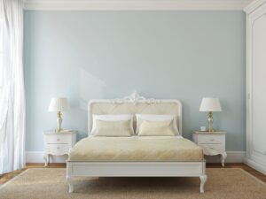 Neatly made bed in a calm, softly lit bedroom