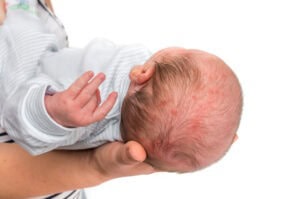 Newborn baby held in an adult's hands
