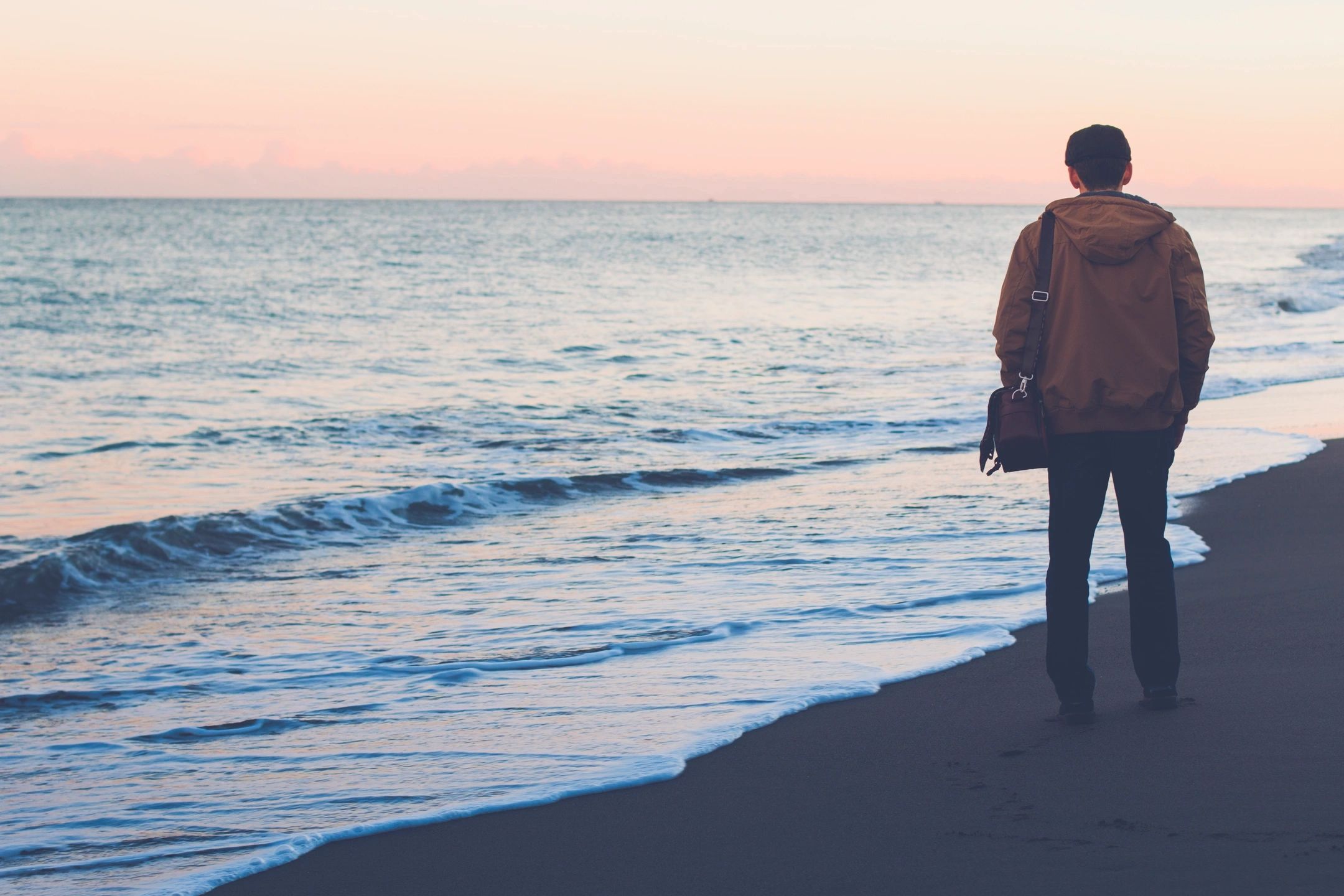 man looking at ocean