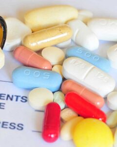 Spilled bottle of assorted prescription pills and capsules